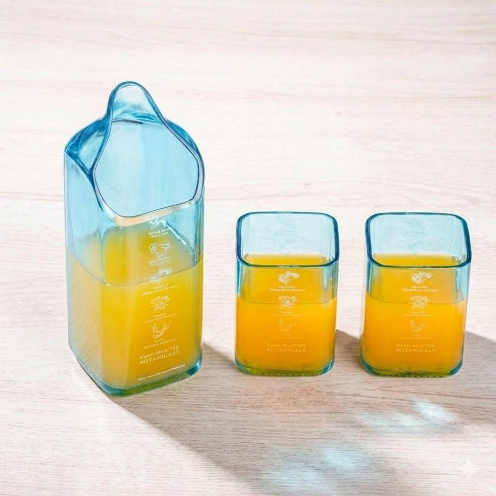 Tall Bombay Sapphire drinkware jug with two matching glasses, featuring elegant design and clear glass material.