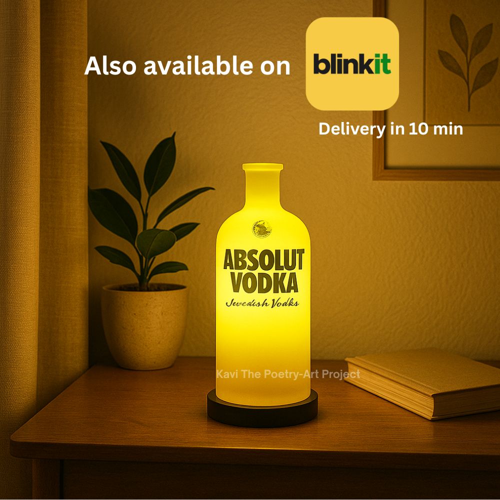 Yellow Absolut Inlit Lamp by Kavi The Poetry-Art Project, shaped like a bottle, glowing with warm yellow light.