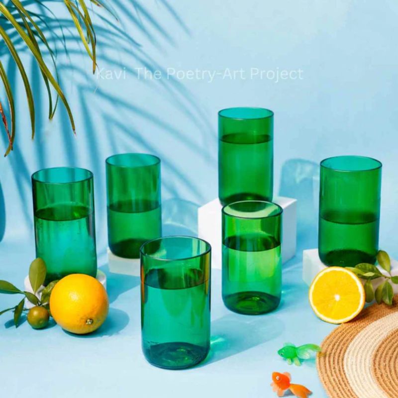 Set of two upcycled green wine bottle glasses from Kavi The Poetry-Art Project, eco-friendly drinkware in a creative design.